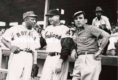 5 x 7 inch photograph. Lionel Hampton in a Kansas City Royals uniform talks to a player of the Cleveland Indians and an unidentified man