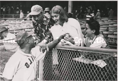 5 x 7 inch photograph. Lionel Hampton in a Kansas City Royals uniform is saluted by fans