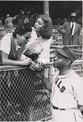 7 x 5 inch photograph. Lionel Hampton in a Kansas City Royals uniform is saluted by fans