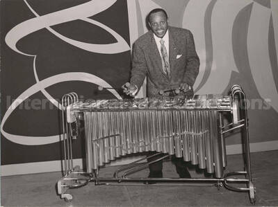 6 1/2 x 9 inch photograph. Lionel Hampton playing a Trixon vibraphone, [in Germany?]