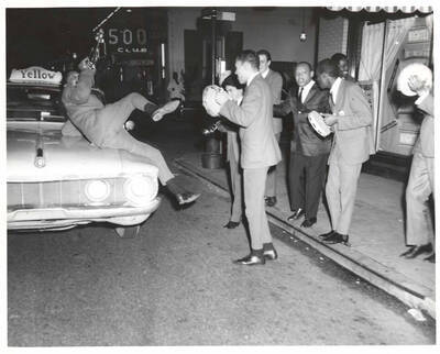 8 x 10 inch photograph. Lionel Hampton with band in front of Al Hirt's New Orleans Bourbon street nightclub. Seen on the background is the marquee of the 500 Club