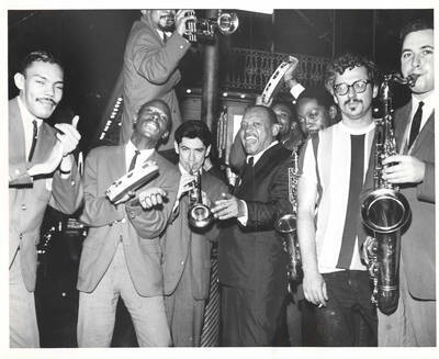 8 x 10 inch photograph. Lionel Hampton with band in front of Al Hirt's New Orleans Bourbon street nightclub. Seen on the background is the marquee of the 500 Club