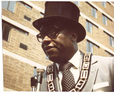 8 x 10 inch photograph. Unidentified member of the Medina Temple speaks at the Grand Opening of Lionel Hampton Houses