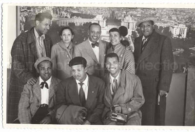 3 1/2 x 5 1/2 inch photograph in the format of postcard. A group photograph with Lionel and Gladys Hampton, Curley Hamner, Leo Moore, and others