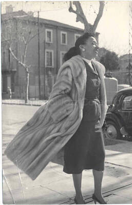 7 x 4 1/2 inch photograph. Gladys Hampton walking down a street [in France?]