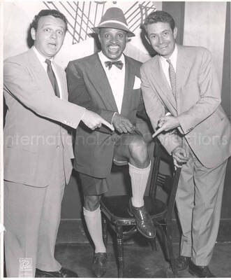 10 x 8 inch photograph. Lionel Hampton with two unidentified man, in a restaurant