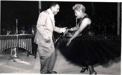 5 x 8 inch photograph. Lionel Hampton performing with band in Israel. Lionel Hampton dances with unidentified vocalist