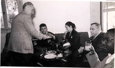 5 x 8 inch photograph. Gladys and Lionel Hampton with band in Israel. Gladys Hampton with unidentified persons