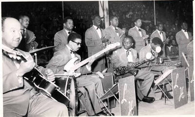 5 x 8 inch photograph. Lionel Hampton performing with band in Israel. Members of the band, which includes guitarist Billy Mackel