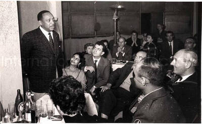5 x 8 inch photograph. Lionel Hampton with unidentified persons in a restaurant in Israel