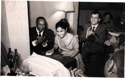5 x 8 inch photograph. Lionel Hampton with unidentified persons in a restaurant in Israel