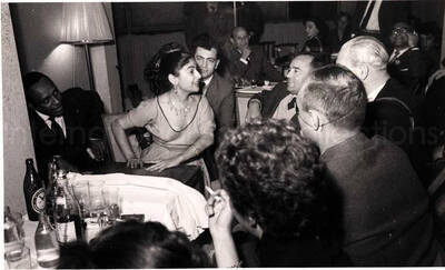5 x 8 inch photograph. Lionel Hampton with unidentified persons in a restaurant in Israel