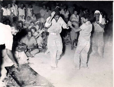 3 1/2 x 5 inch photograph. The Fire Gang. This photograph was in a photo album with a dedication that read: To Lionel Hampton and his band; our little gift may remind you one of the nights in Israel and the Fire Gang. Caption under the photograph read: A dance at one of the Fire Gang partys