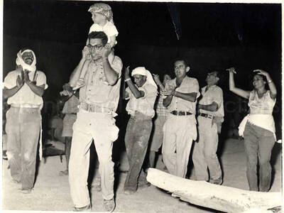 3 1/2 x 5 inch photograph. The Fire Gang. This photograph was in a photo album with a dedication that read: To Lionel Hampton and his band; our little gift may remind you one of the nights in Israel and the Fire Gang. Caption under the photograph read: At the opening ceremony