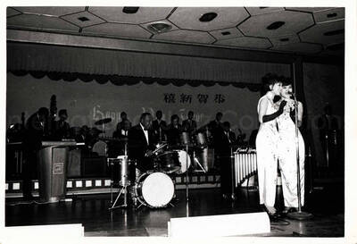 3 1/2 x 5 inch photograph. Lionel Hampton's band with two unidentified women dressed in Japanese costume, singing in Japan
