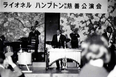3 x 4 1/2 inch photograph. Lionel Hampton playing the vibraphone with band, in Osaka, Japan