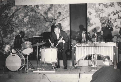 3 x 4 1/2 inch photograph. Lionel Hampton playing the drums with band, in Osaka, Japan