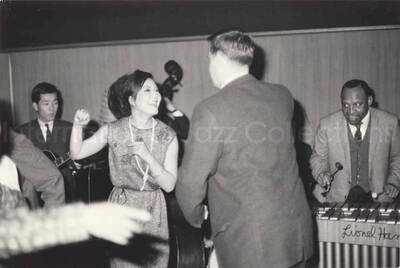 3 x 4 1/2 inch photograph. Lionel Hampton playing the vibraphone with band, in Osaka, Japan