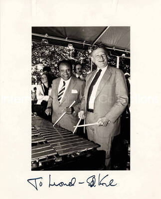 10 x 8 inch photograph. Lionel Hampton with Edward I. Koch, Mayor of the City of New York playing the vibraphone, at the kick-off of the JVC Jazz Festival. New York, NY. Accompanying this photograph is a letter from the photographer to Chuck Jones, dated from August 4, 1988, and a newspaper clipping