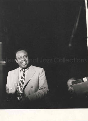 9 1/2 x 7 inch photograph. Lionel Hampton performing. Seen on the background is Billy Mackel [in Geneva, Switzerland?]