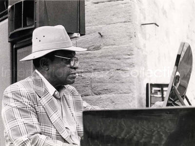 7 x 9 1/2 inch photograph. Lionel Hampton playing the piano [in Marseille, France?]. Handwritten on the back of the photograph: Salon