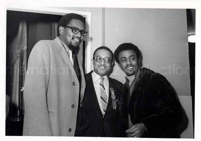 5 x 7 inch photograph. Johnny Taylor (right) and two unidentified men