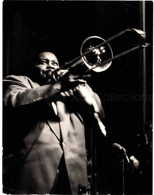 7 1/2 x 5 3/4 inch photograph. Unidentified trombonist
