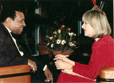 8 x 11 inch photograph. Lionel Hampton with unidentified woman at the Charles Hotel, Boston. From a scrapbook