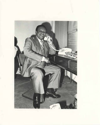10 x 8 inch photograph. Lionel Hampton on the telephone with a pack of Sherman's Phantom cigarette on the table