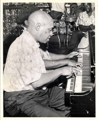 10 x 8 inch photograph. Lionel Hampton playing the piano alongside with unidentified pianist