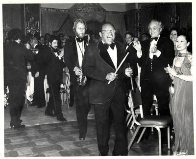 8 x 10 inch photograph. Lionel Hampton on vibraphone performing with band at a formal reception