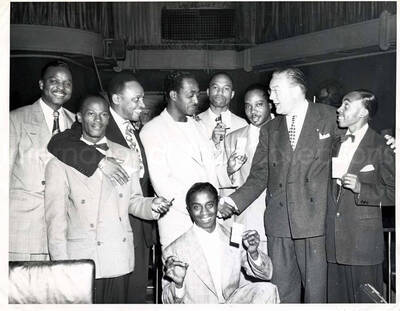 8 x 10 inch photograph. Lionel Hampton with unidentified men