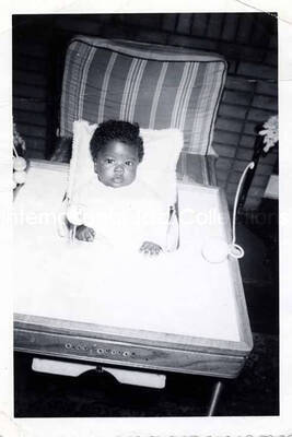 5 x 3 1/2 inch photograph. A baby. Handwritten on the back of the photograph: Gladys and Curley