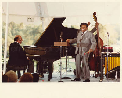 8 x 10 inch photograph. Lionel Hampton with unidentified pianist and others at an outdoor concert at the White House. This concert was aired January 27, 1982 on the public television special, Great Vibes! Lionel Hampton and Friends, as part of the Kennedy Center Tonight series