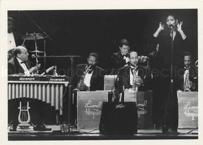 5 x 7 inch photograph. Lionel Hampton with band and unidentified vocalist. [Lionel Hampton's 90th birthday at the Blue Note in New York]