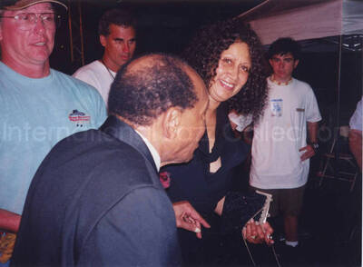 5 x 7 inch photograph. Lionel Hampton with unidentified persons. Handwritten on the back of the photograph: Musician Day; June 22-28, 1998; On the River Front; Nashville, TN