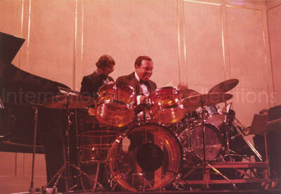 5 x 7 inch photograph. Lionel Hampton  on drums with band. Handwritten on the back of the photograph: Teatro El Circulo, Rosario, Argentina; Lionel Hampton All Stars. This photograph has a dedication from Wis Contijoch and Ruben Gonzalez