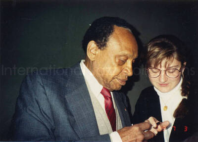 3 1/2 x 5 inch photograph. Lionel Hampton signing autographs