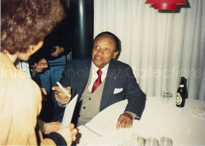 3 1/2 x 5 inch photograph. Lionel Hampton signing autographs