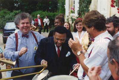 4 x 6 inch photograph. Lionel Hampton with unidentified persons, at a ceremony related to wine [in France]