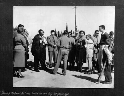 10 x 10 inch photograph. Lionel Hampton in Israel. This photograph is in a photo album titled: In the Holy City - Jerusalem. Caption under the photograph reads: Maleh Hahamisha was build in one day 30 years ago