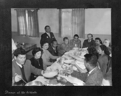 8 x 10 inch photograph. Lionel Hampton in Israel. This photograph is in a photo album titled: In the Holy City - Jerusalem. Caption under the photograph reads: Dinner at the kibbutz