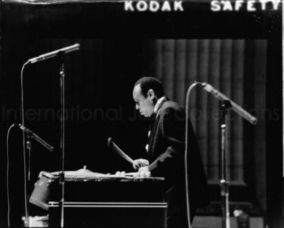 14 x 17 1/2 inch photograph. Lionel Hampton playing the vibraphone. Handwritten on the back of the photograph is the name of the photographer, the date, and: Department of Treasury, Wash. D.C.