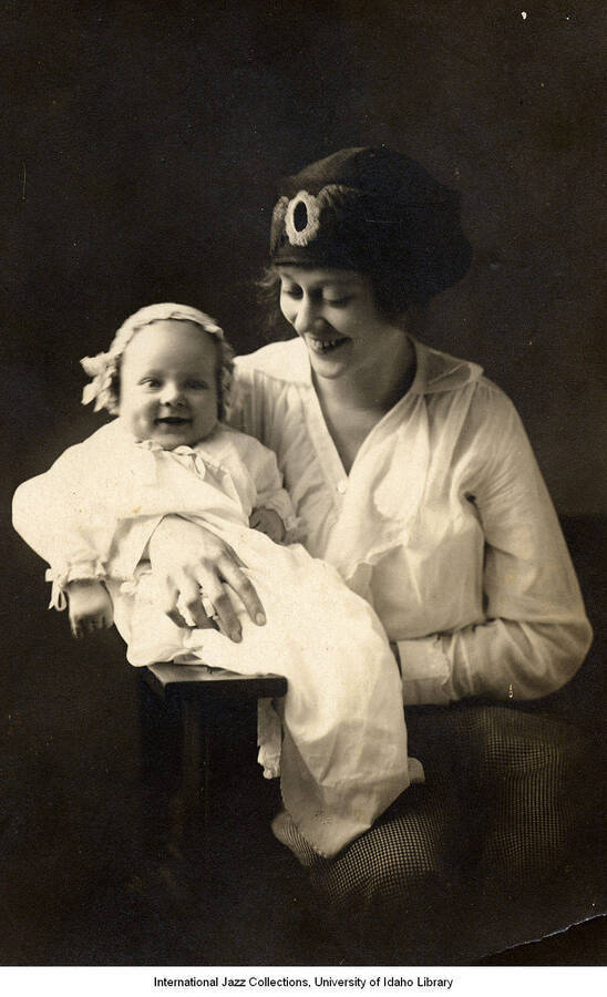 Portrait of Lee Morse holding a baby in her arms.