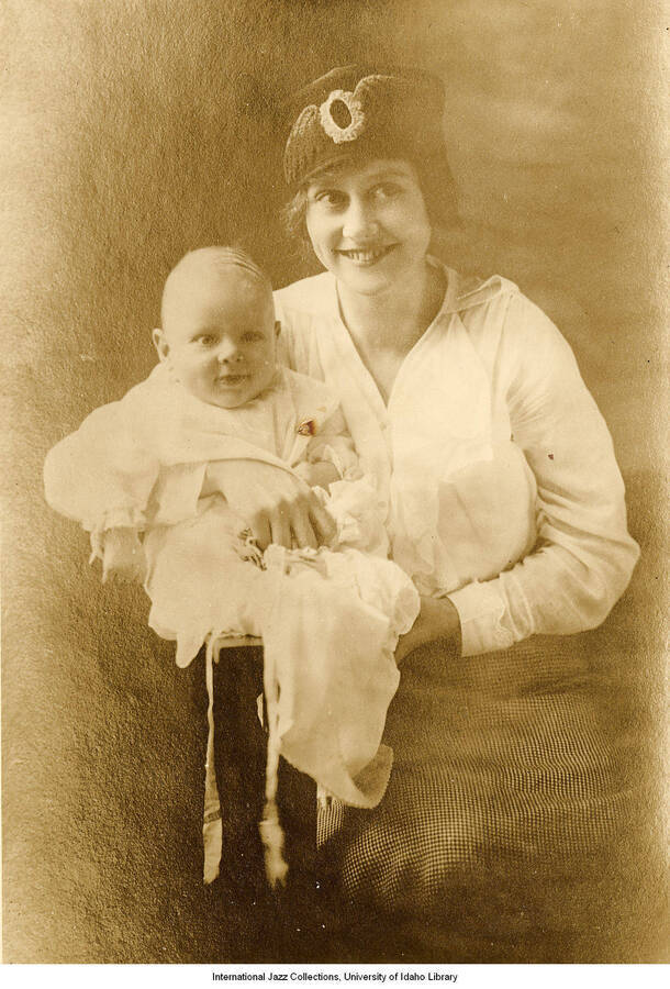 Portrait of Lee Morse holding a baby in her arms.