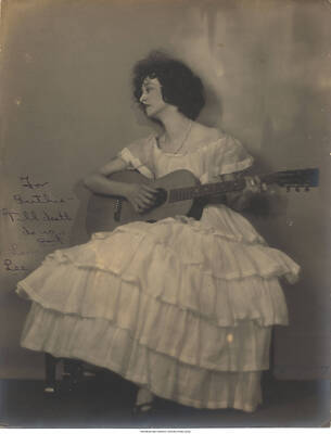 Black and white photograph of Lee Morse holding a guitar. Inscription: For Ruthie- 'Till death do us part!"  Love Lee.