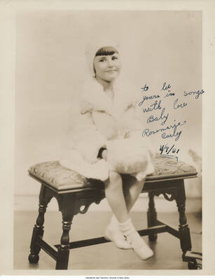 Black and white photograph of a child. Inscription: "To Lee yours is songs with love  Baby Rosemarie Curley  11/9/31"