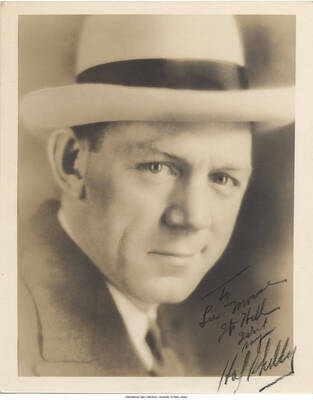 Black and white photograph of a man. Inscription: "To Lee Morse Its Hell [] [] Hal Skelly"