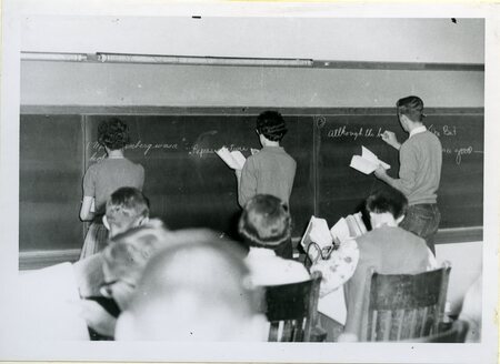 students at chalkboard