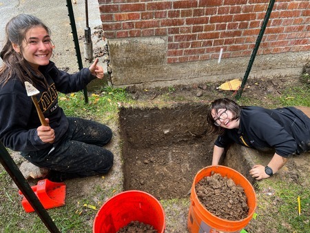 UI Students (left to right): Zoe Rafter and Grace Gardner, digging a unit at MHS
